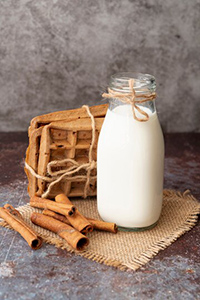 high-angle-waffles-with-cinnamon-sticks-milk-bottle_23-2148422796